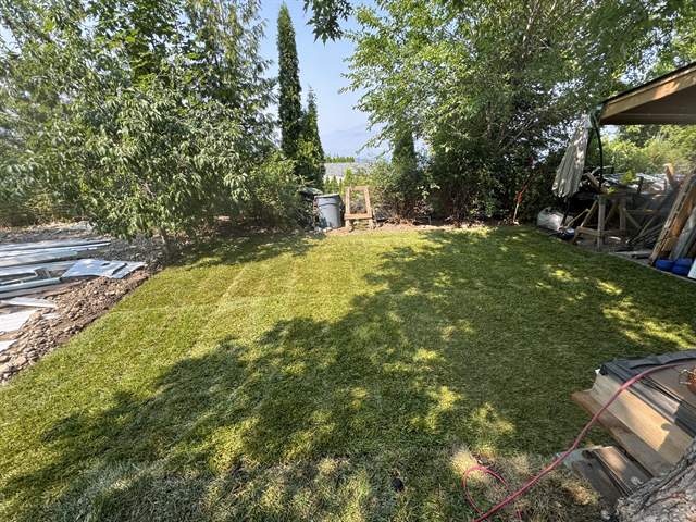 Fresh sod being installed on a prepared backyard lawn